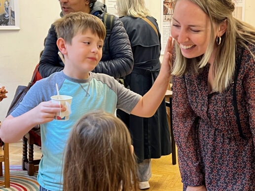 Elliot Kooi chats with Samantha Gutheil, who's talking with his younger sister, Lucy Kooi.