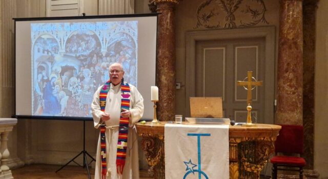 The pastor is speaking to the congregation in the church